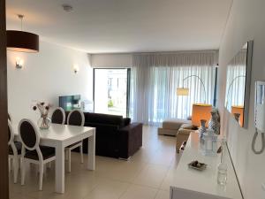 a living room with a couch and a table at Cavalo Preto Luxury Beach Resort in Quarteira