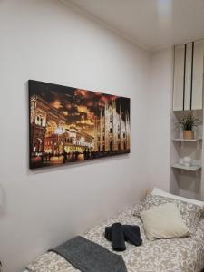 a bedroom with a picture of a cathedral on the wall at Sweet Home Milano B&B in San Donato Milanese