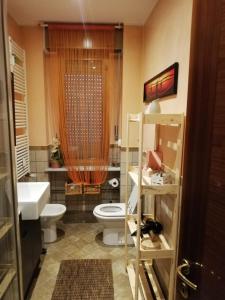 La salle de bains est pourvue de toilettes et d'un lavabo. dans l'établissement Sweet Home Milano B&B, à San Donato Milanese
