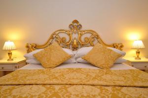 a bed with an ornate headboard and pillows at House 5286 in Venice