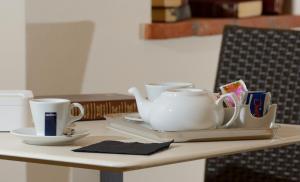 una mesa con dos tazas y un set de té. en Hotel San Sebastiano en Perugia