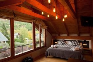 a bedroom with a bed and a large window at Can Congost in Sort