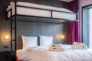 Rúm í herbergi á BLOOM Boutique Hotel & Lounge Basel