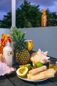 a plate of fruit and vegetables on a table at joli appartement avec vue au Moule in Le Moule