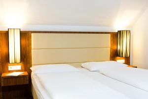 Postel nebo postele na pokoji v ubytování Hotel Kapeller Innsbruck