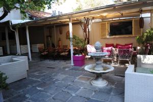a stone patio with a fountain in a yard at Студия Давидов "Studios Davidoff"- апартаменти под наем in Plovdiv