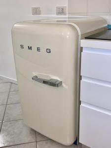 a white refrigerator in a kitchen next to a counter at [Storico] Ombelico di Parma in Parma