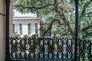 a black iron fence in front of a house at Malaga Inn in Mobile