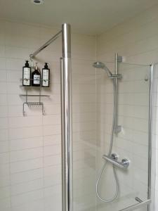 a shower in a bathroom with a glass shower stall at Stylish City Centre Flat in Leeds