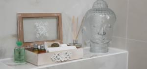 a white shelf with a picture and a statue at Old Town Apartment in Poznań
