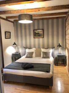 a bedroom with a bed and a lamp at Carpe Diem Home - Au pied de la Cathédrale in Strasbourg
