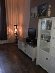 a room with a cabinet with a television on it at Das Rübezahl in Bad Elster