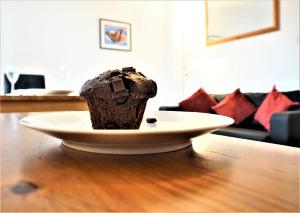 a cupcake sitting on a plate on a table at Palmer's Apartment in Bristol