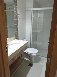a bathroom with a toilet and a sink and a shower at Park Veredas, Flat 407 - Rio Quente - GO in Rio Quente