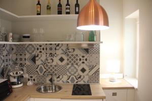 a kitchen with a sink and a pendant light at Residenza del Maestro in Matera