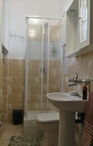 a bathroom with a shower and a sink and a toilet at Casa Bianca in Marina di Massa