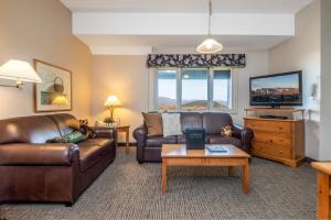 a living room with a leather couch and a tv at Jordan Hotel in Newry