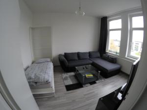 ein Wohnzimmer mit einer Couch und einem Bett in der Unterkunft Clean & Central 2 Room Apartment 50m² in Hannover