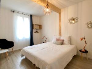 a bedroom with a white bed and a window at Charming Home - City Center Cosy Apartments in Colmar