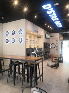 a room with tables and stools in a laundry room at Dz Studio and Suite Parisien Tower i-City in Shah Alam