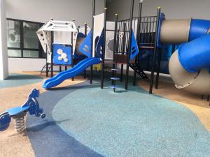 a playground with a blue slide at Dz Studio and Suite Parisien Tower i-City in Shah Alam