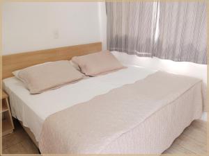 Postel nebo postele na pokoji v ubytování Hotel Anjos LTDA