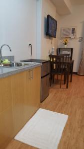 a kitchen with a sink and a counter top at Mesaverte Residences AFS Suites in Cagayan de Oro