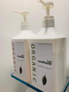 two bottles ofodorizers are sitting on a shelf at WELLSTAY Honmachi in Osaka