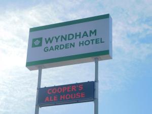 a sign for a wandeland garden hotel and a sign for at Wyndham Garden Greensboro in Greensboro