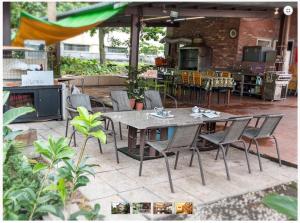 a patio with a table and chairs and a kitchen at GuiZhuLin B&B in Jiaoxi