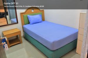 Postel nebo postele na pokoji v ubytování Hotel Graha DPT 33