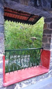 a red bench sitting on the side of a building at Wildernest in Thekkady