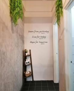 a hallway with a quote on the wall at Wanderer In Melaka in Malacca
