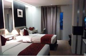 Tempat tidur dalam kamar di Gino Feruci Braga by KAGUM Hotels