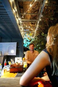 a man and a woman sitting at a counter in a restaurant at The Spice Trail in Arugam Bay