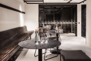 a restaurant with two tables and chairs and a window at Blique by Nobis, Stockholm, a Member of Design Hotels™ in Stockholm