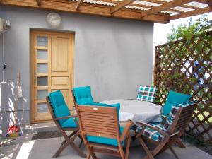 a table and chairs sitting on a patio at Lenart House 1 in Siófok