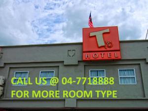 a hotel with a sign on top of a building at T Hotel Tandop in Alor Setar