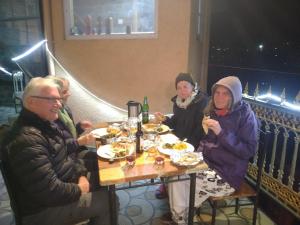 a group of people sitting at a table eating food at Apple House in Shimla