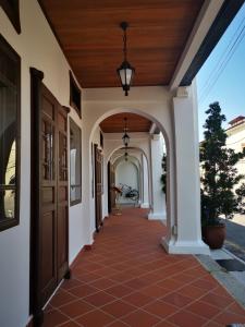 a hallway of a house with a wooden ceiling at Mclane Boutique Hotel in George Town