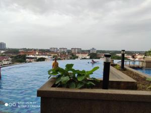 a swimming pool in a city with people swimming at DPerdana -Dinies pool,wifi, centre of Kota Bharu, 4-5 pax in Kota Bharu