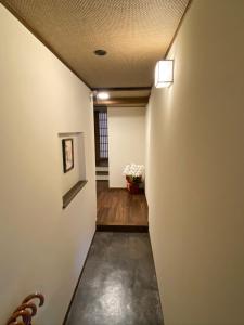 a hallway with white walls and a ceiling at Private House HidaTakayama in Takayama