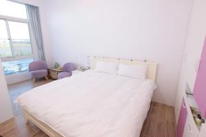 En eller flere senger på et rom på 兆億申襄采民宿1741 Zhao Yì Shen Xiang Cai Homestay 1741