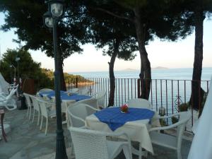 a row of tables and chairs with a view of the ocean at Milia Bay Hotel Apartments in Milia