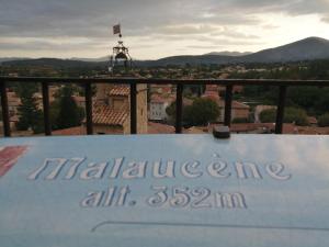 a sign on top of a building with a view at LE PETIT VENTOUX VILLAGE in Malaucène
