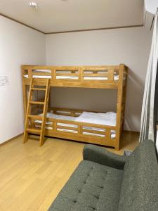 sypialnia z 2 łóżkami piętrowymi i kanapą w obiekcie Guest House En w mieście Nara