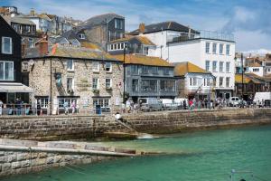 a person in a boat in the water near a river at Lifeboat Inn in St Ives