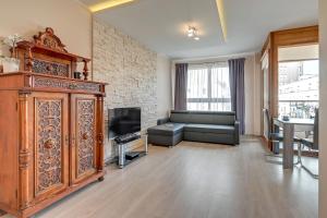 Televízia a/alebo spoločenská miestnosť v ubytovaní GRANO FLATS Gdańsk - Aura I