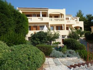 a house with a garden in front of it at Milia Bay Hotel Apartments in Milia