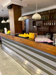 a bar in a restaurant with a counter with drinks at Alva Donna Hotel in Kotelniki
